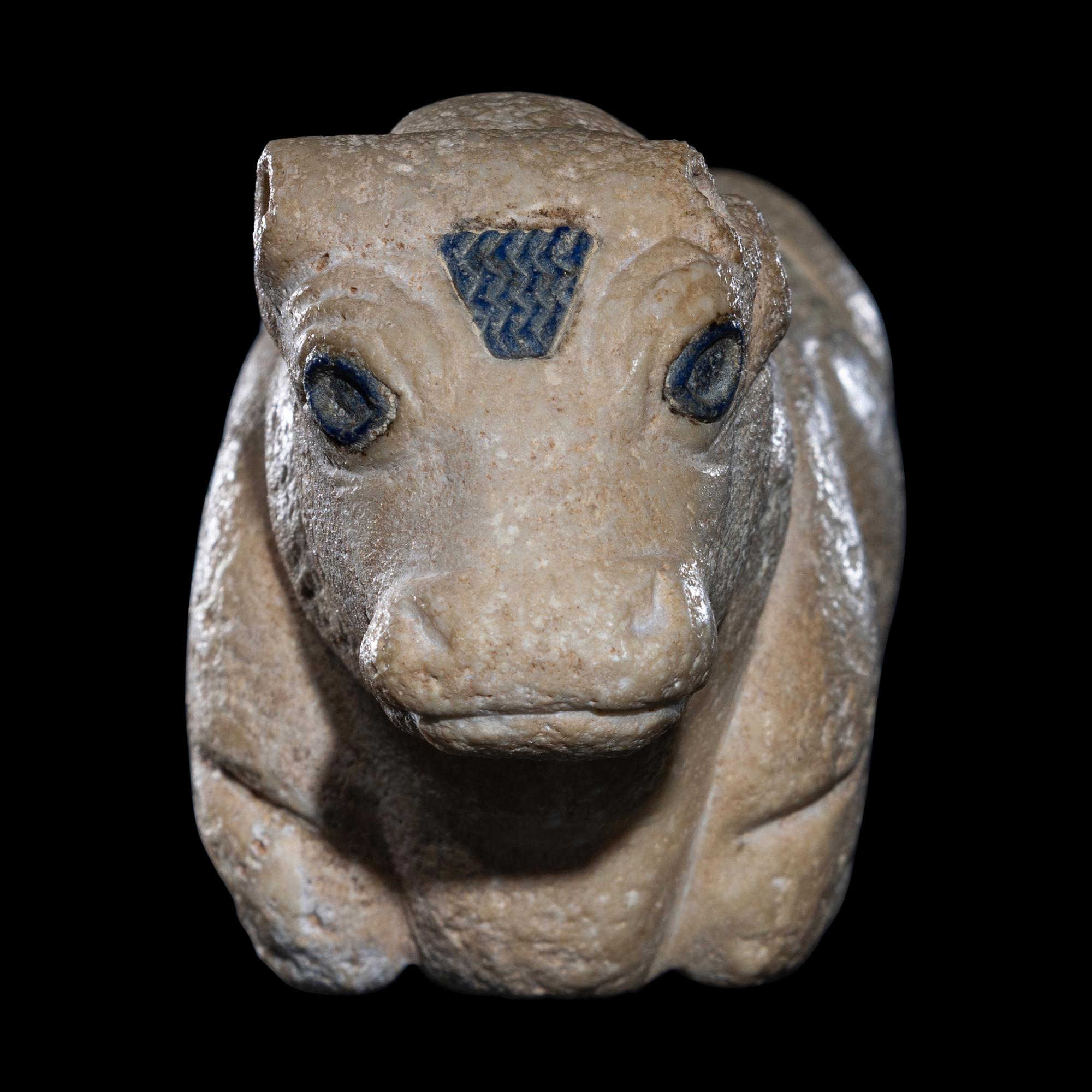 A Mesopotamian Limestone Recumbent Bull with Lapis Lazuli Inlays