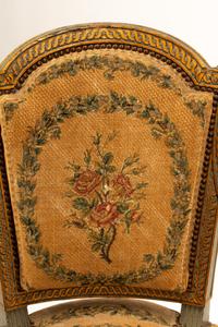 A Pair of French Neoclassical Painted and Parcel Gilt Armchairs
