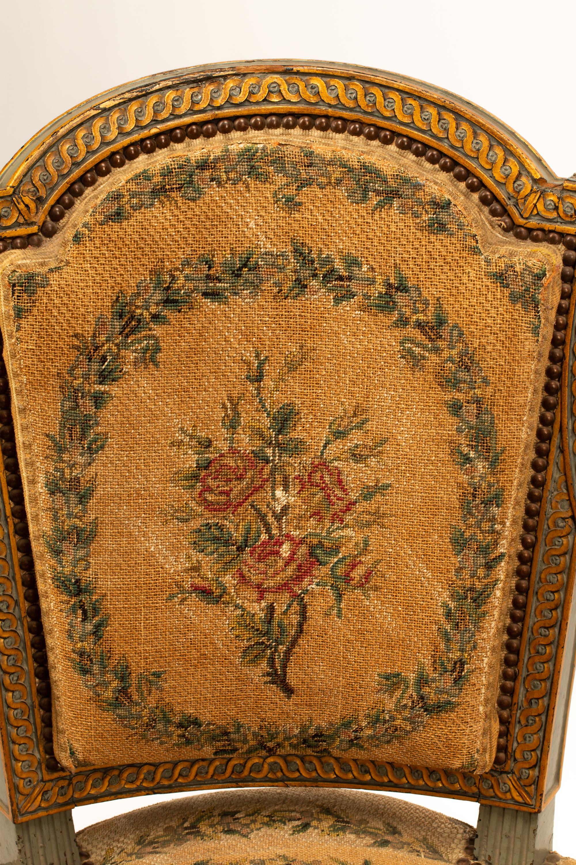 A Pair of French Neoclassical Painted and Parcel Gilt Armchairs