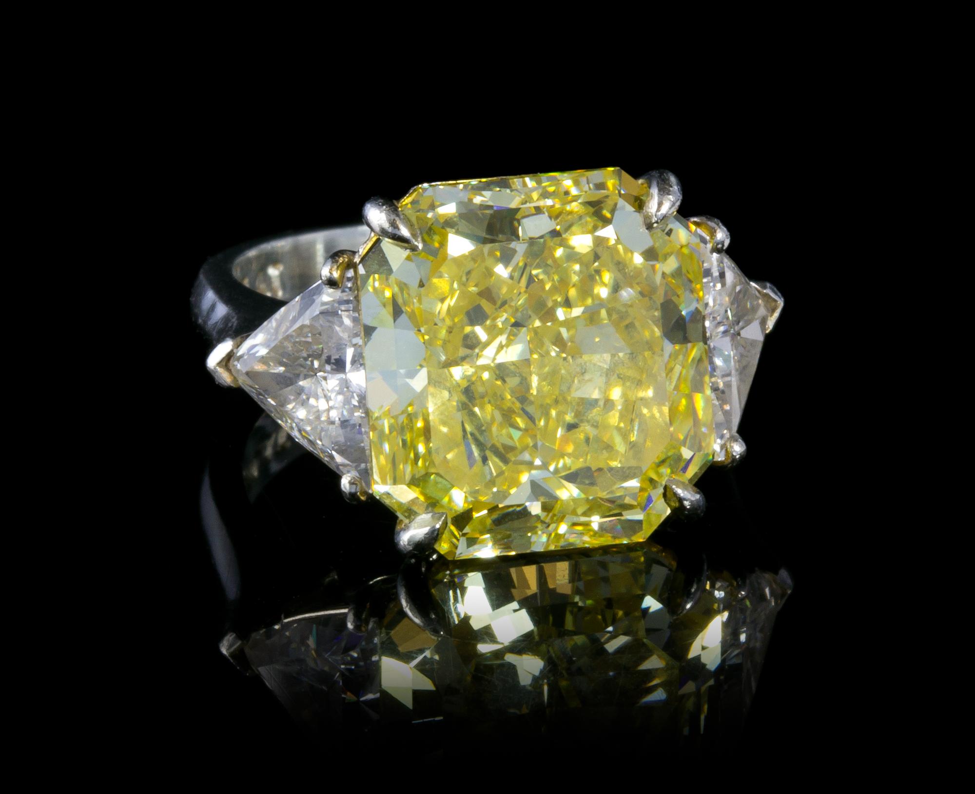A Fine Platinum, Fancy Intense Yellow Diamond and Diamond Ring, 7.40 dwts.