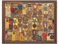 [CIVIL WAR - GRAND ARMY OF THE REPUBLIC]. A large framed collection of GAR and auxiliary organization medals and badges, including:
