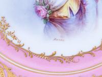 A Pair of Sèvres Painted and Parcel Gilt Pink-Ground Porcelain Plates