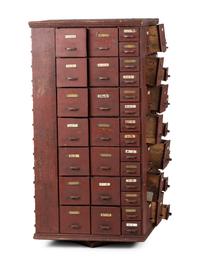 A Rotating Hardware Store Storage Cabinet in Red Paint