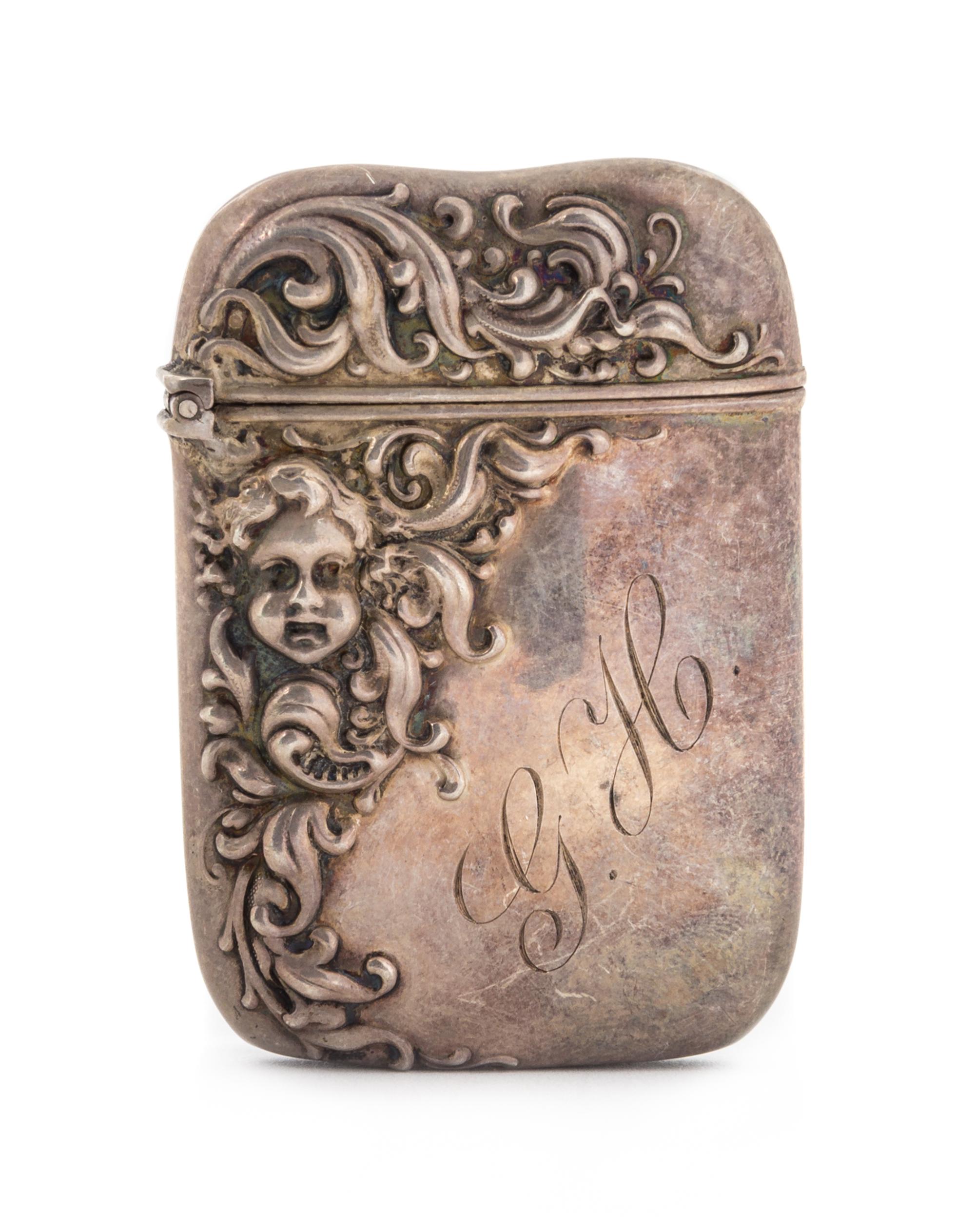 An American Silver Vesta Case, Possibly John Hasselbring, Brooklyn, NY, the body decorated with repousse foliate volutes and a putti ma