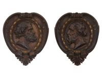 A Pair of Continental Carved Oak and Parcel Gilt Profile Plaques