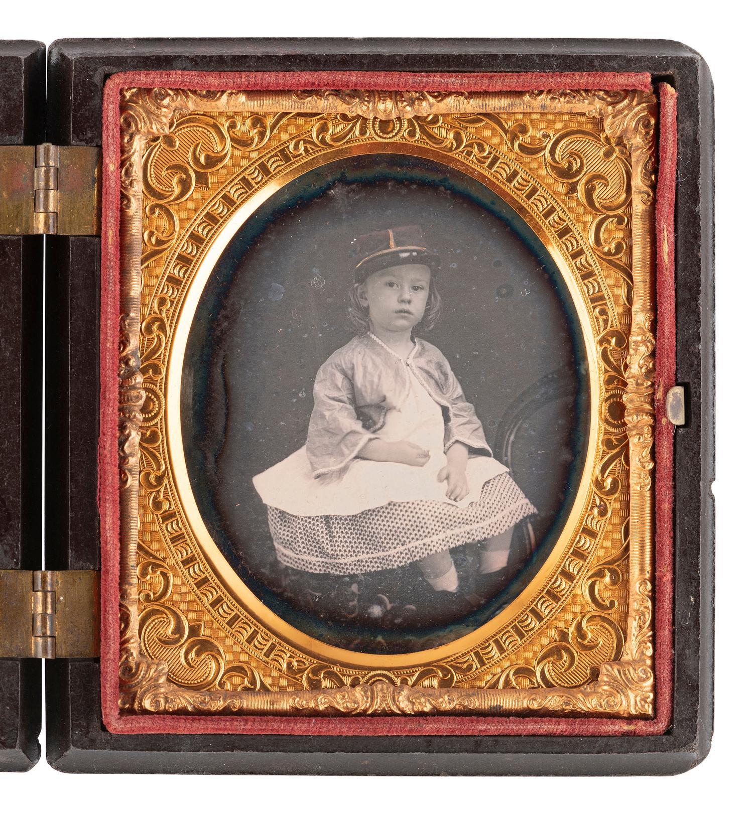 [CIVIL WAR]. Likely pre-war sixth plate daguerreotype portrait of a young girl wearing a kepi.