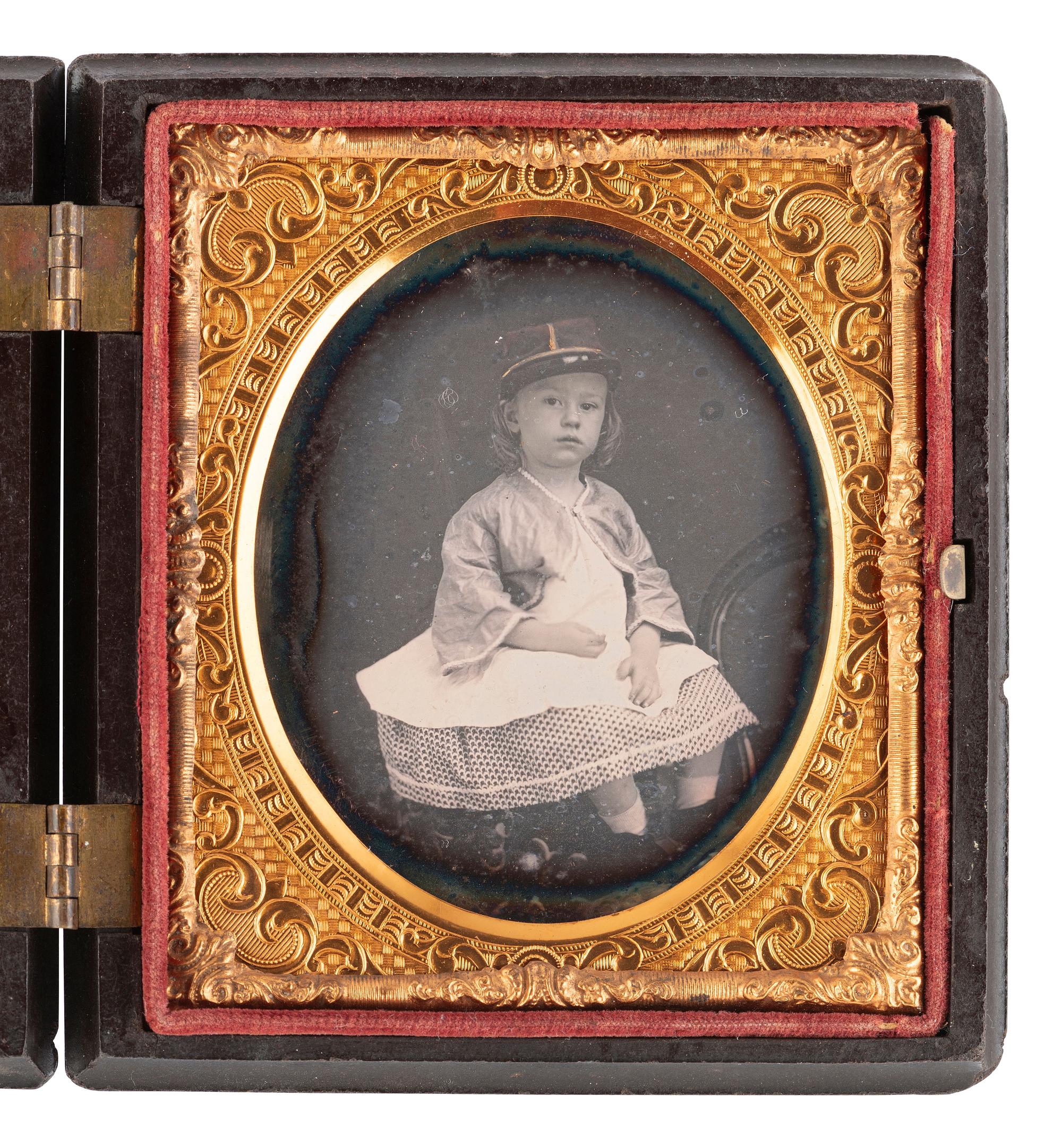 [CIVIL WAR]. Likely pre-war sixth plate daguerreotype portrait of a young girl wearing a kepi.
