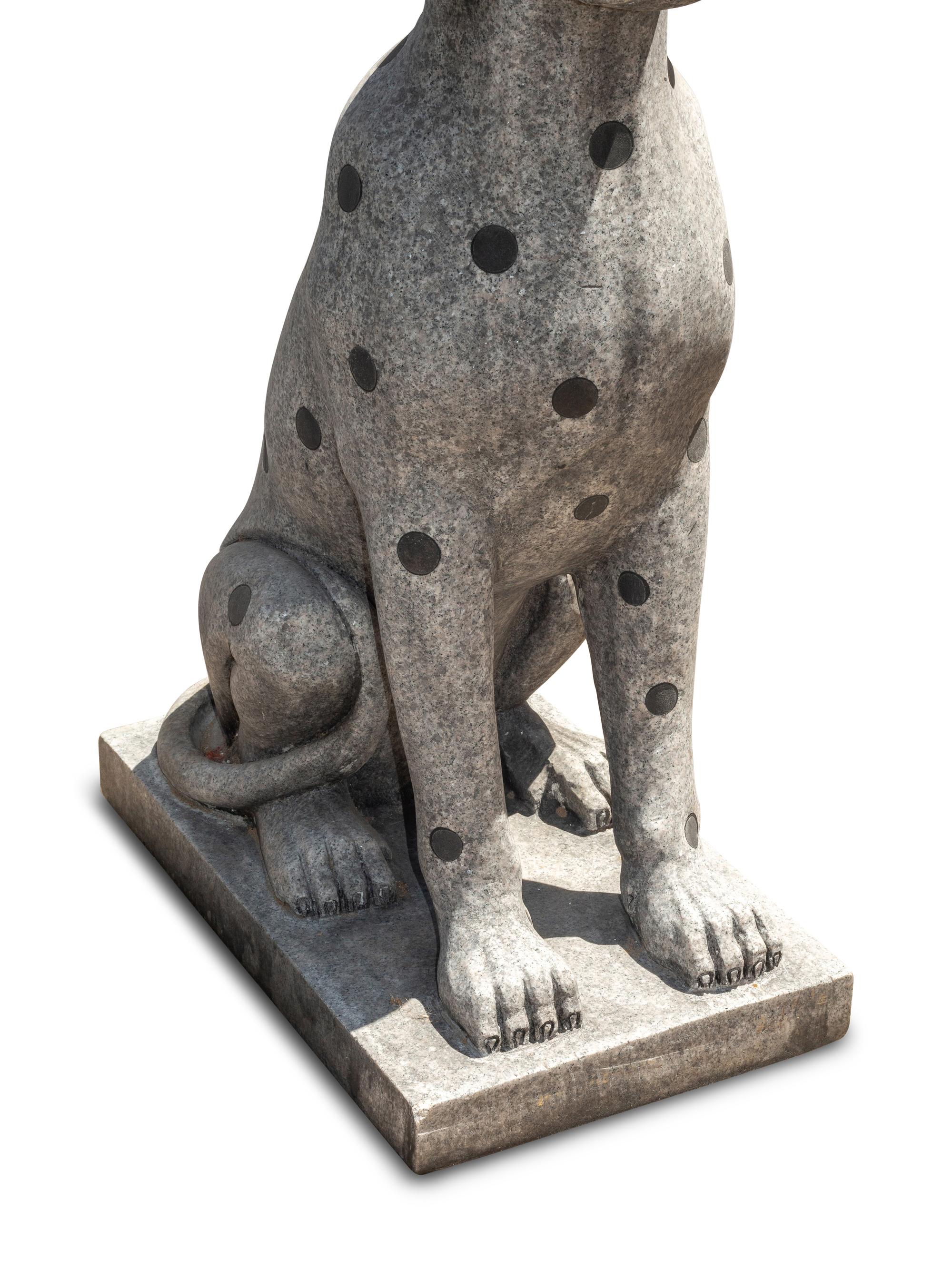 A Pair of Carved Granite and Black Marble Inlaid Seated Dogs