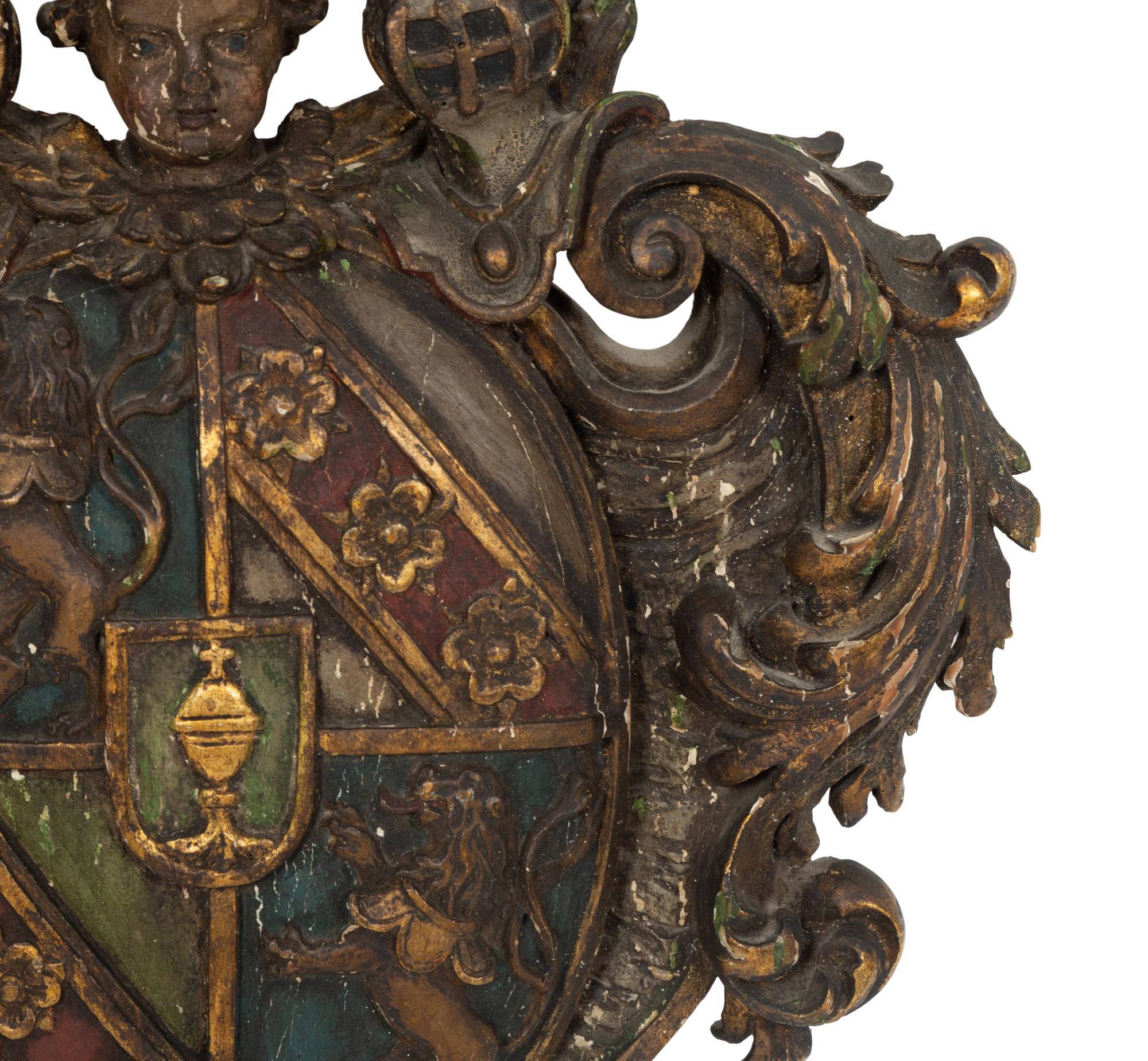 An Italian Painted and Parcel Gilt Carved Armorial Plaque