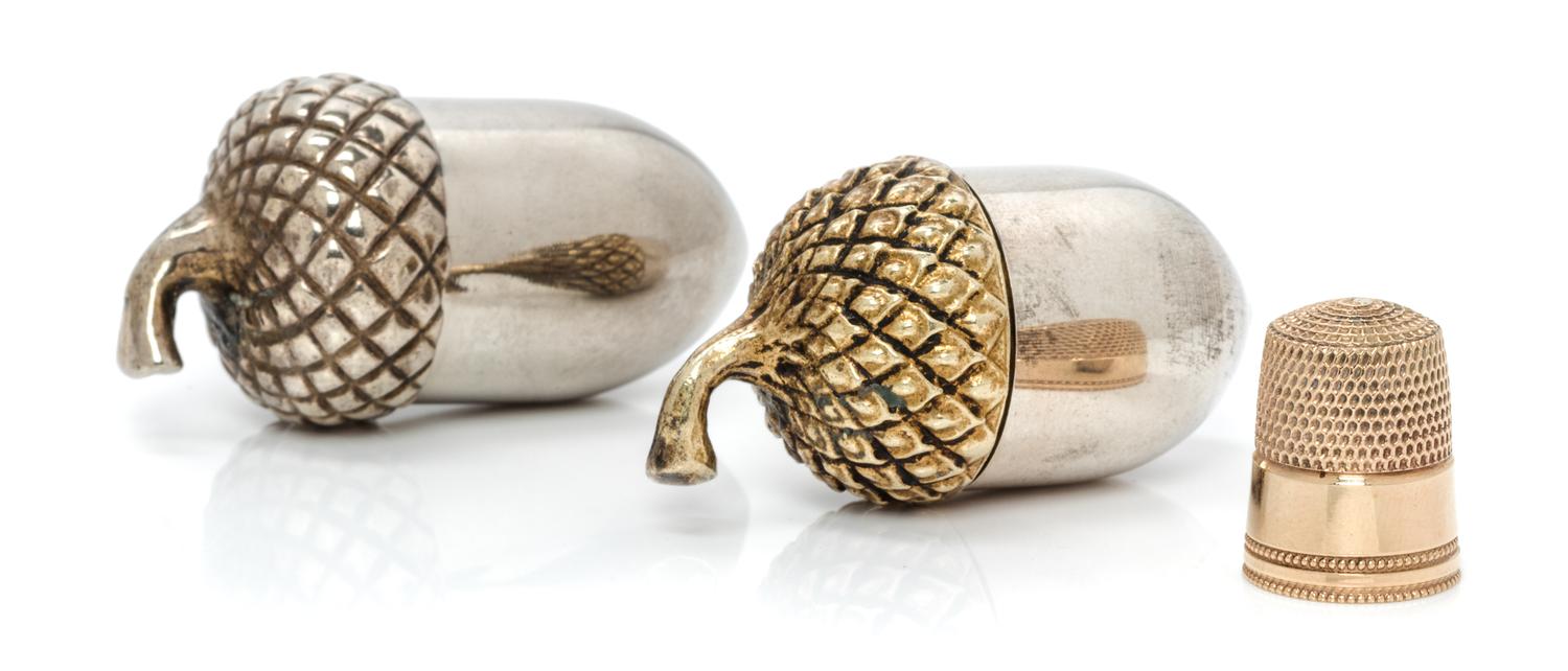 An American 14-Karat Gold Thimble and Acorn-Form Case, Tiffany & Co., New York, NY, the thimble having a dimpled top and body with a be