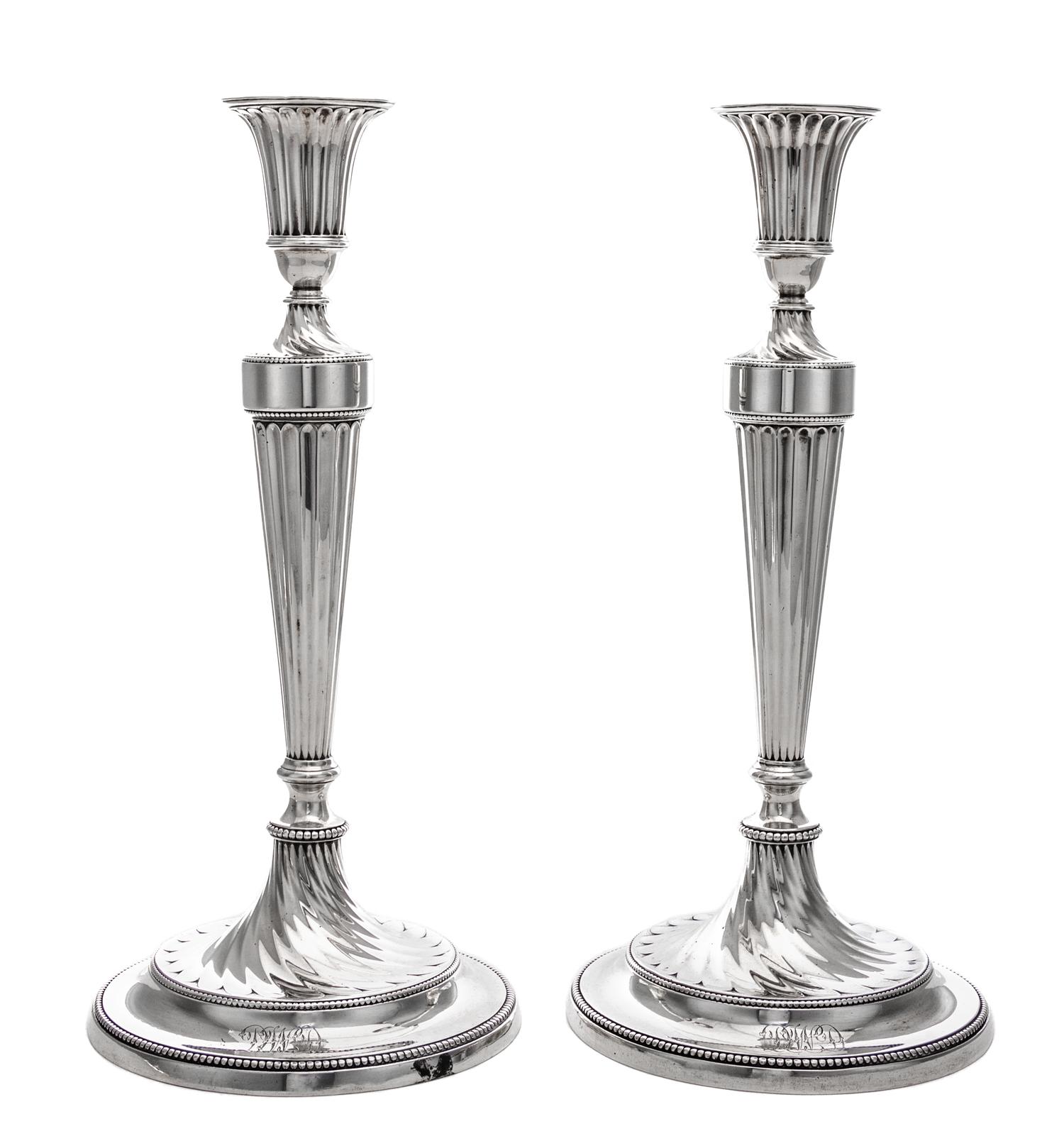 A Pair of George III Silver Candlesticks, John Schofield, London, 1781-2, the fluted candle cup above the fluted tapering stem ending i