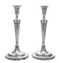 A Pair of George III Silver Candlesticks, John Schofield, London, 1781-2, the fluted candle cup above the fluted tapering stem ending i