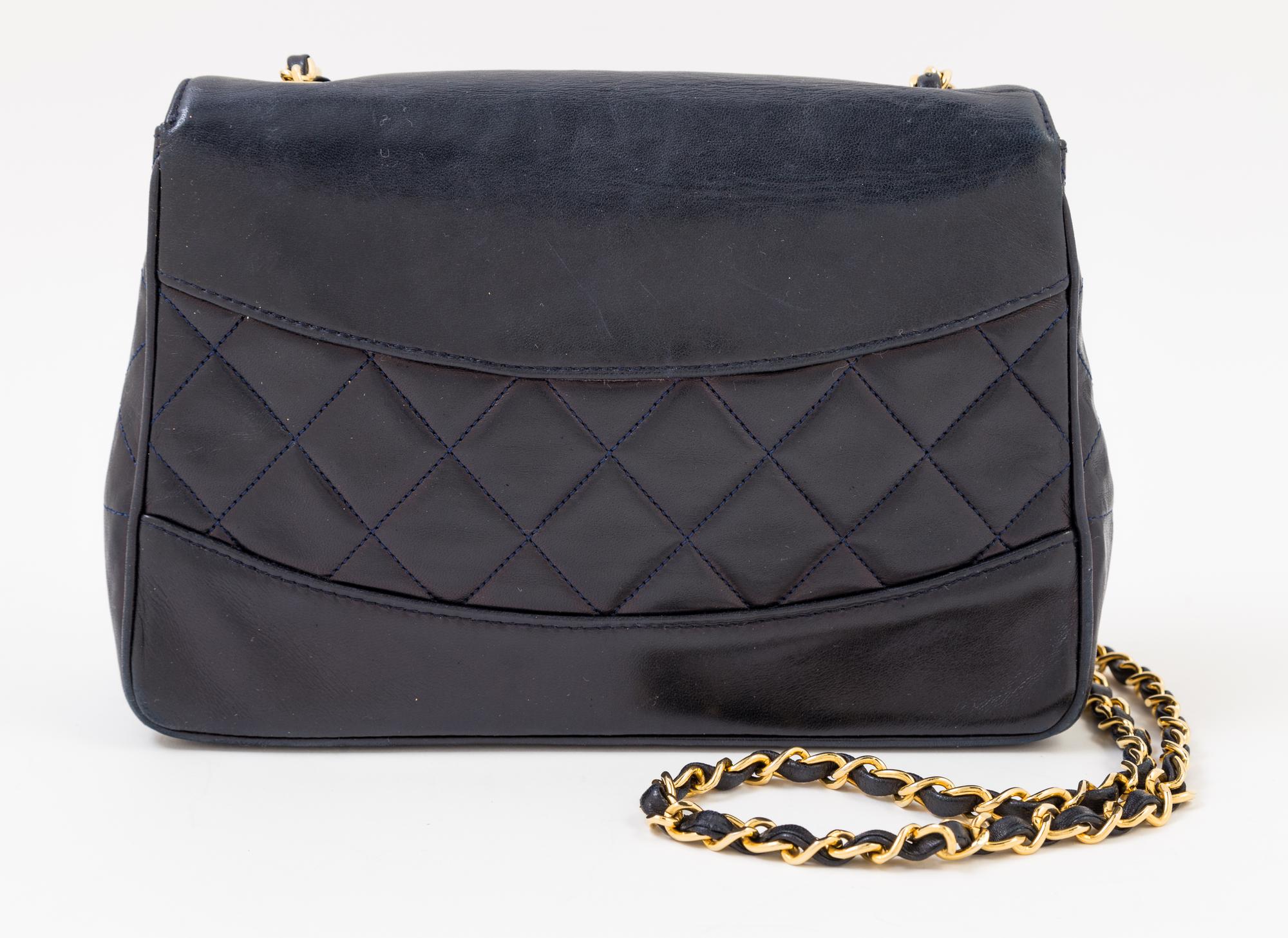 A Chanel Navy Lambskin Flap Shoulder Bag, 9.5" x 6.5" x 3"; Strap drop: 21".
