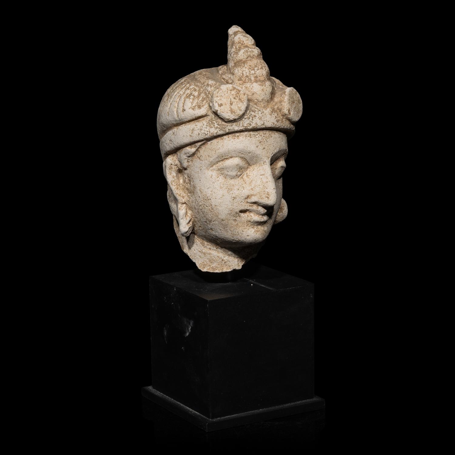 A Gandharan Stucco Head of Maitreya, Hadda Region, 4th/5th Century