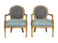 A Pair of Louis XVI Style Cream-Painted and Parcel Gilt Fauteuils with Needlepoint Backs
