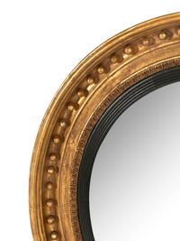 A Pair of Regency Carved Giltwood Convex Wall Mirrors