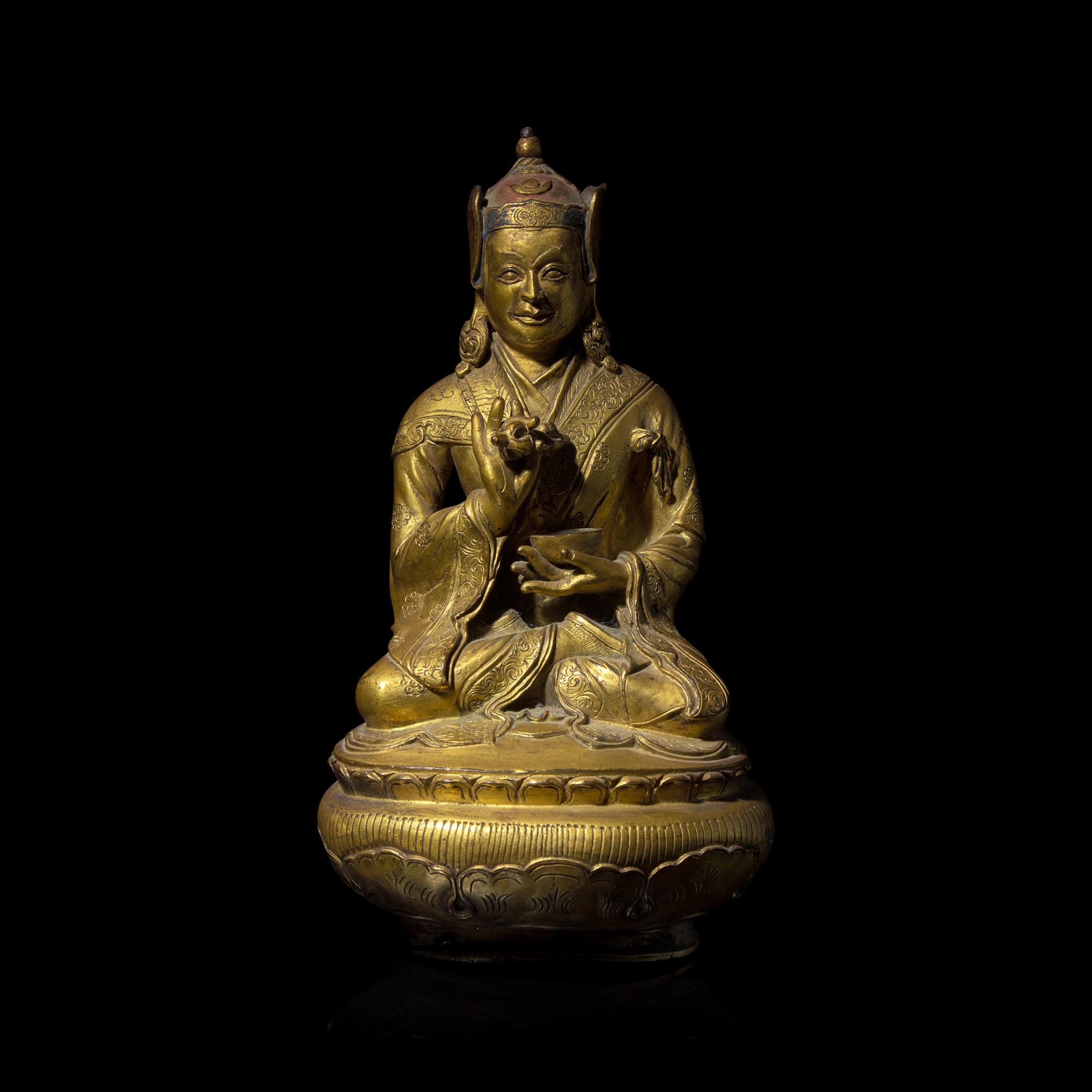 A Tibetan Gilt Copper Alloy Figure of Padmasambava, 18th/19th Century or Earlier 十八/十九世紀或更早 銅合金蓮花生坐像