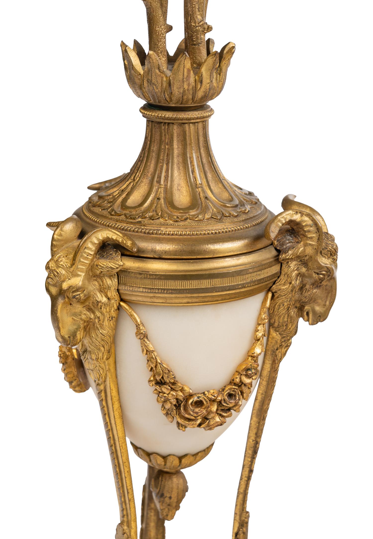 An Assembled French Gilt Bronze Mounted Marble Three-Piece Clock Garniture