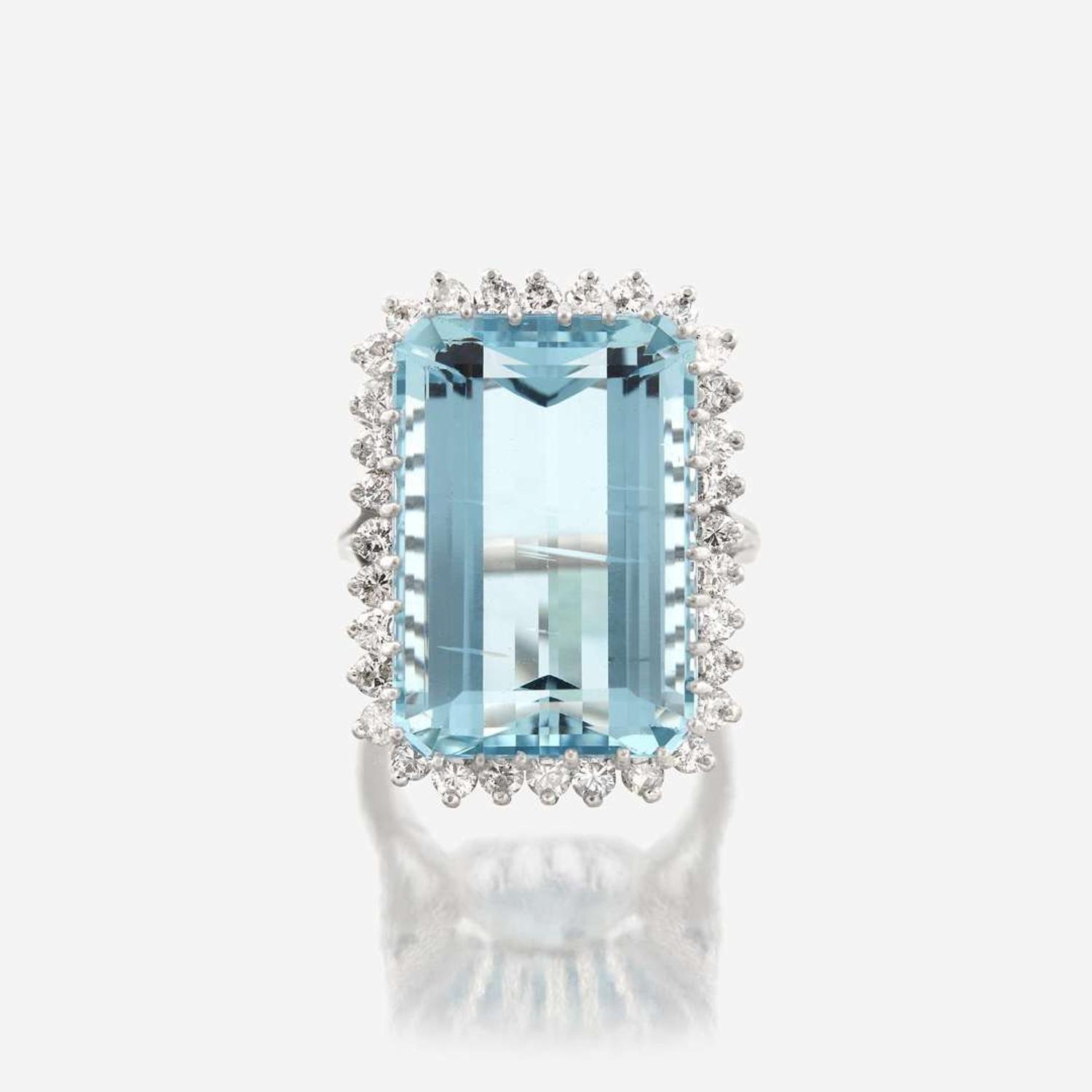 An aquamarine, diamond, and fourteen karat white gold ring