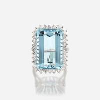 An aquamarine, diamond, and fourteen karat white gold ring
