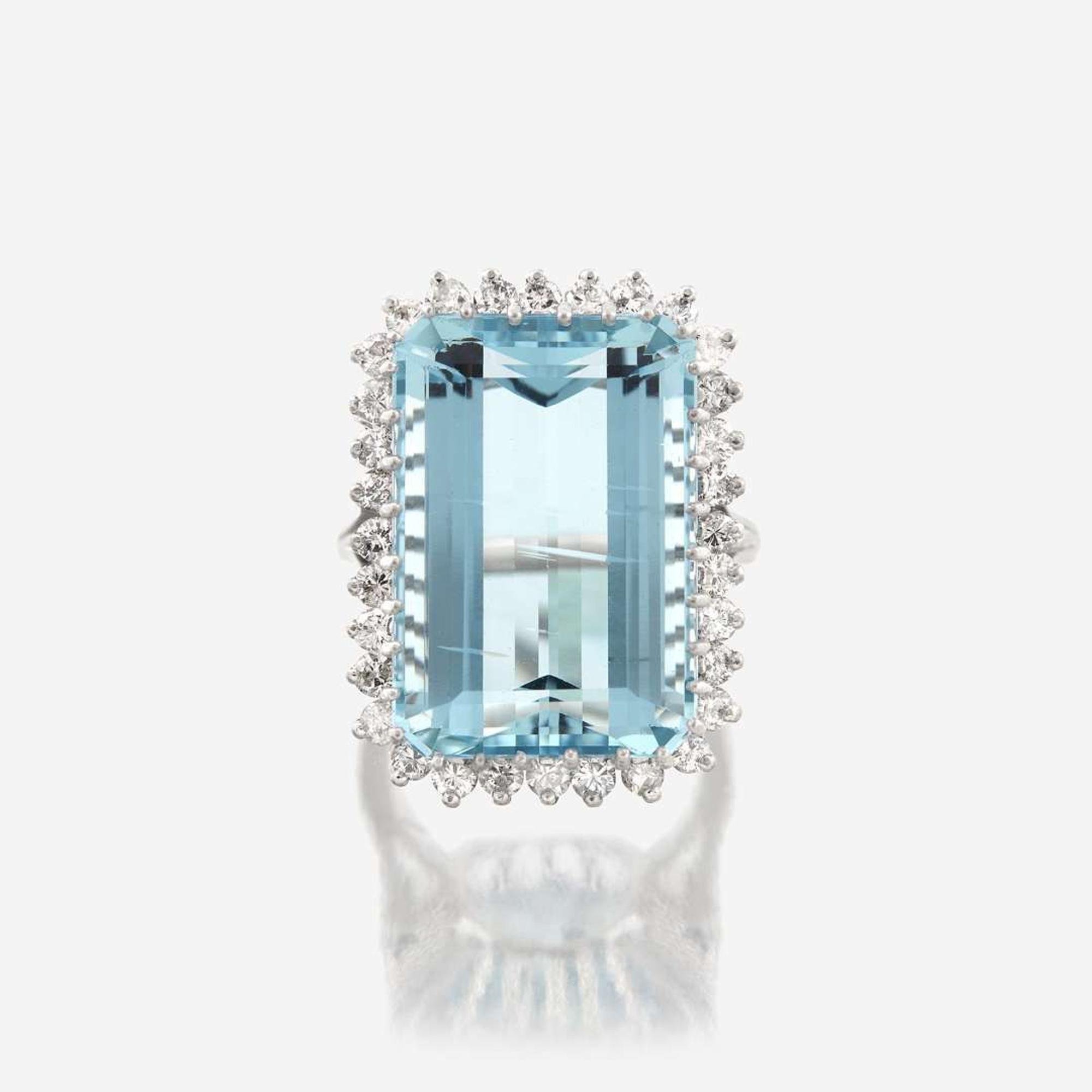 An aquamarine, diamond, and fourteen karat white gold ring