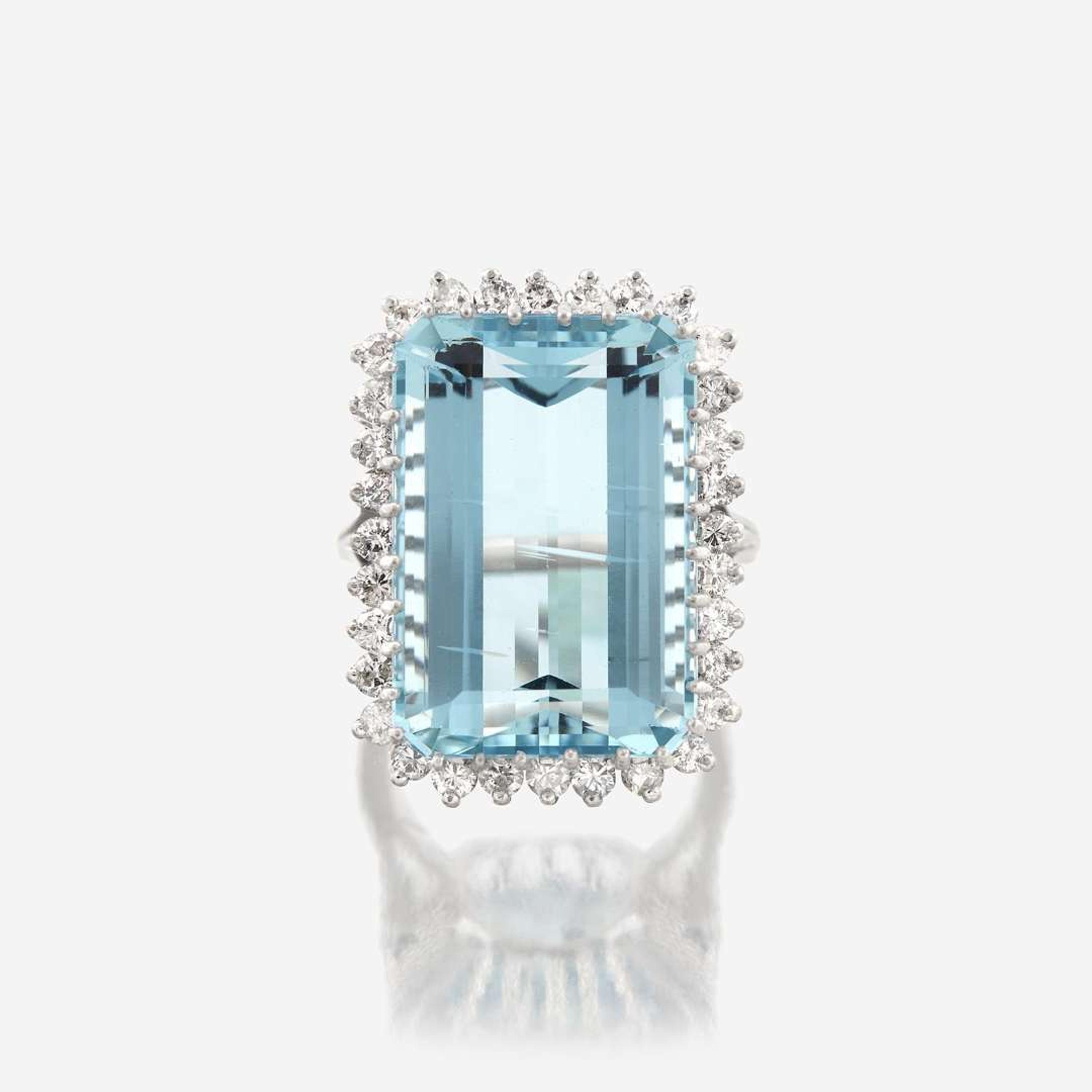 An aquamarine, diamond, and fourteen karat white gold ring