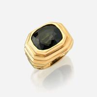 A color change alexandrite and eighteen karat gold ring