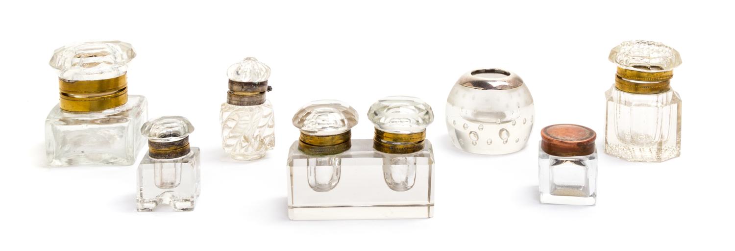 A Group of Seven Glass Inkwells Height of tallest 2 1/4 inches.