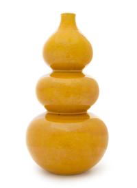 A Yellow Glazed Porcelain Triple Gourd-Form Bottle Vase Height 16 1/2 inches.