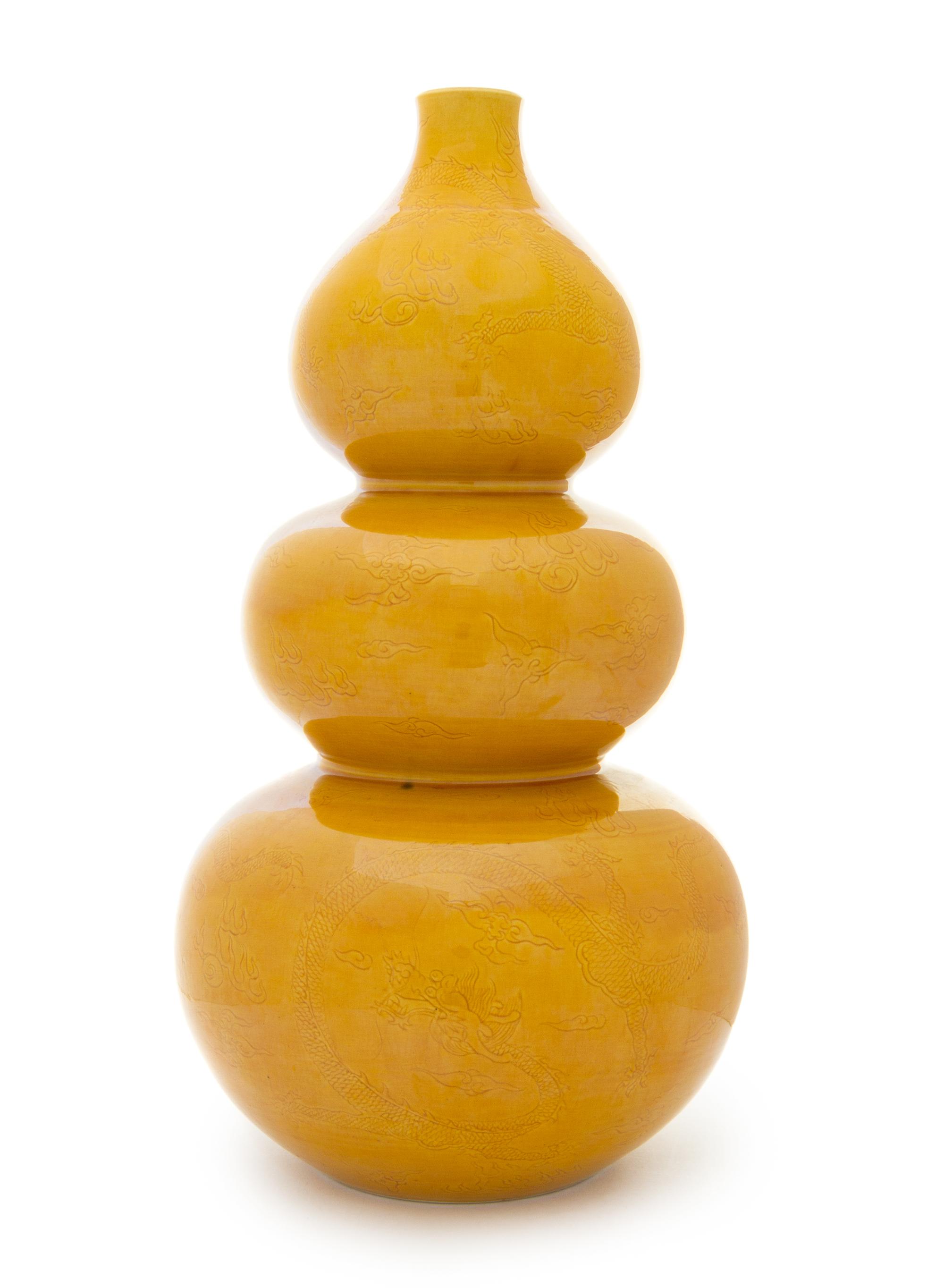 A Yellow Glazed Porcelain Triple Gourd-Form Bottle Vase Height 16 1/2 inches.