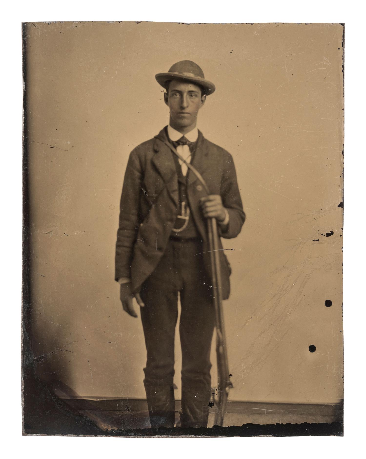 [EARLY PHOTOGRAPHY - TINTYPE]. A group of 4 tintype portraits of civilians with weapons, including: