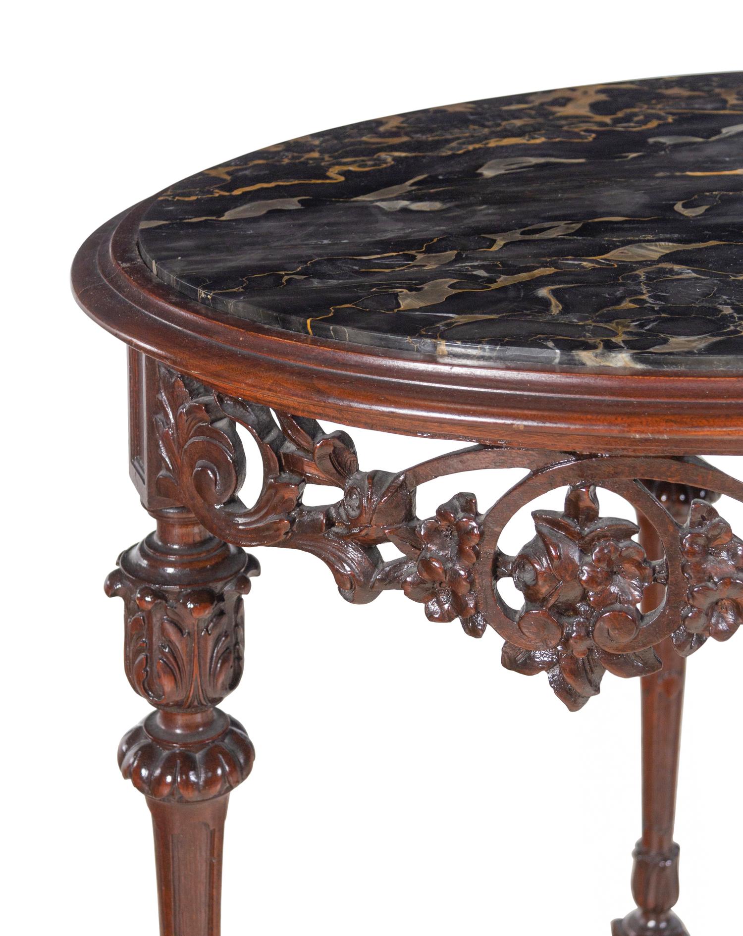 An Italian Carved Walnut Marble-Top Table