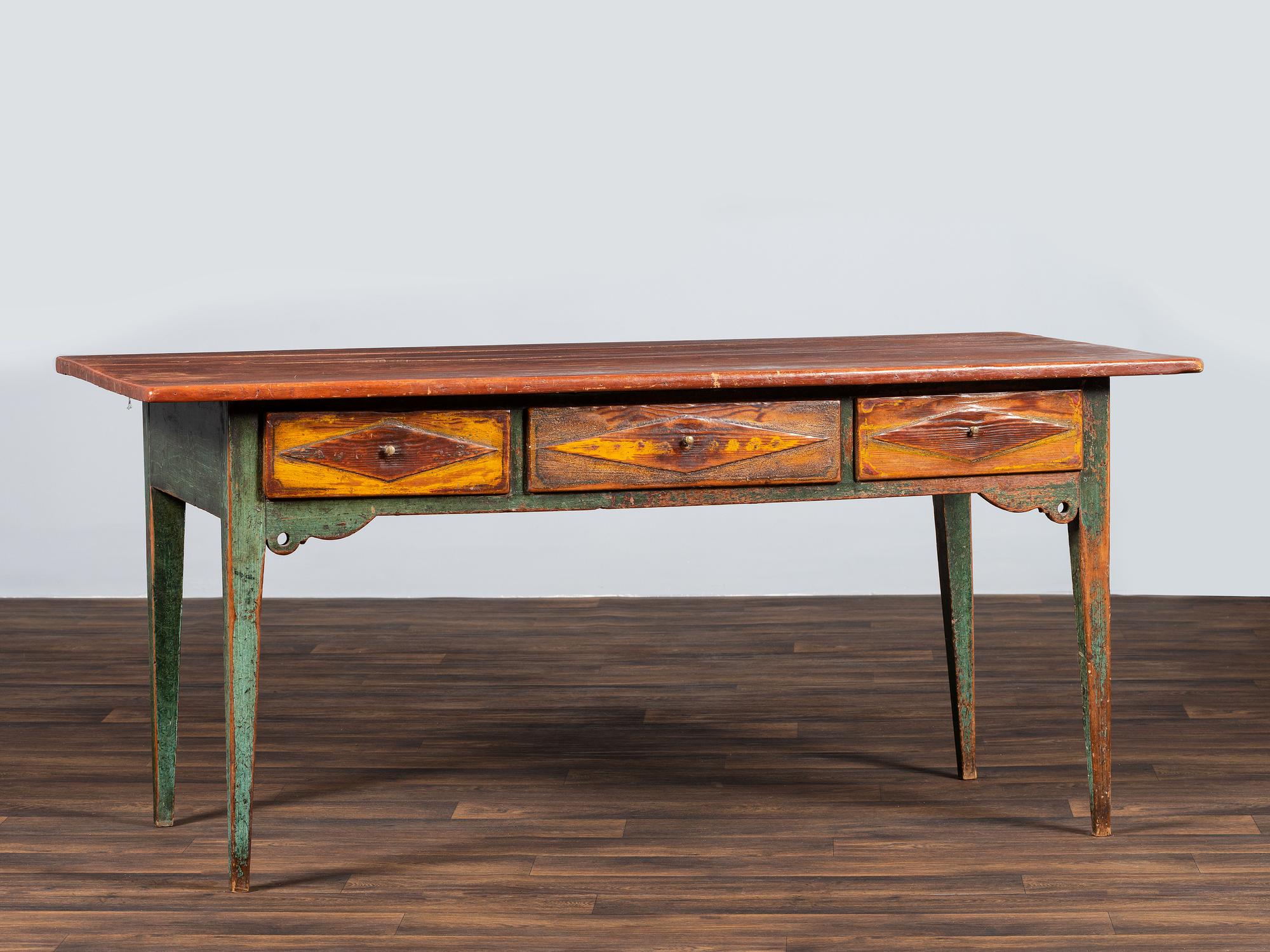 A Country Paint Decorated Pine Three-Drawer Farm Table