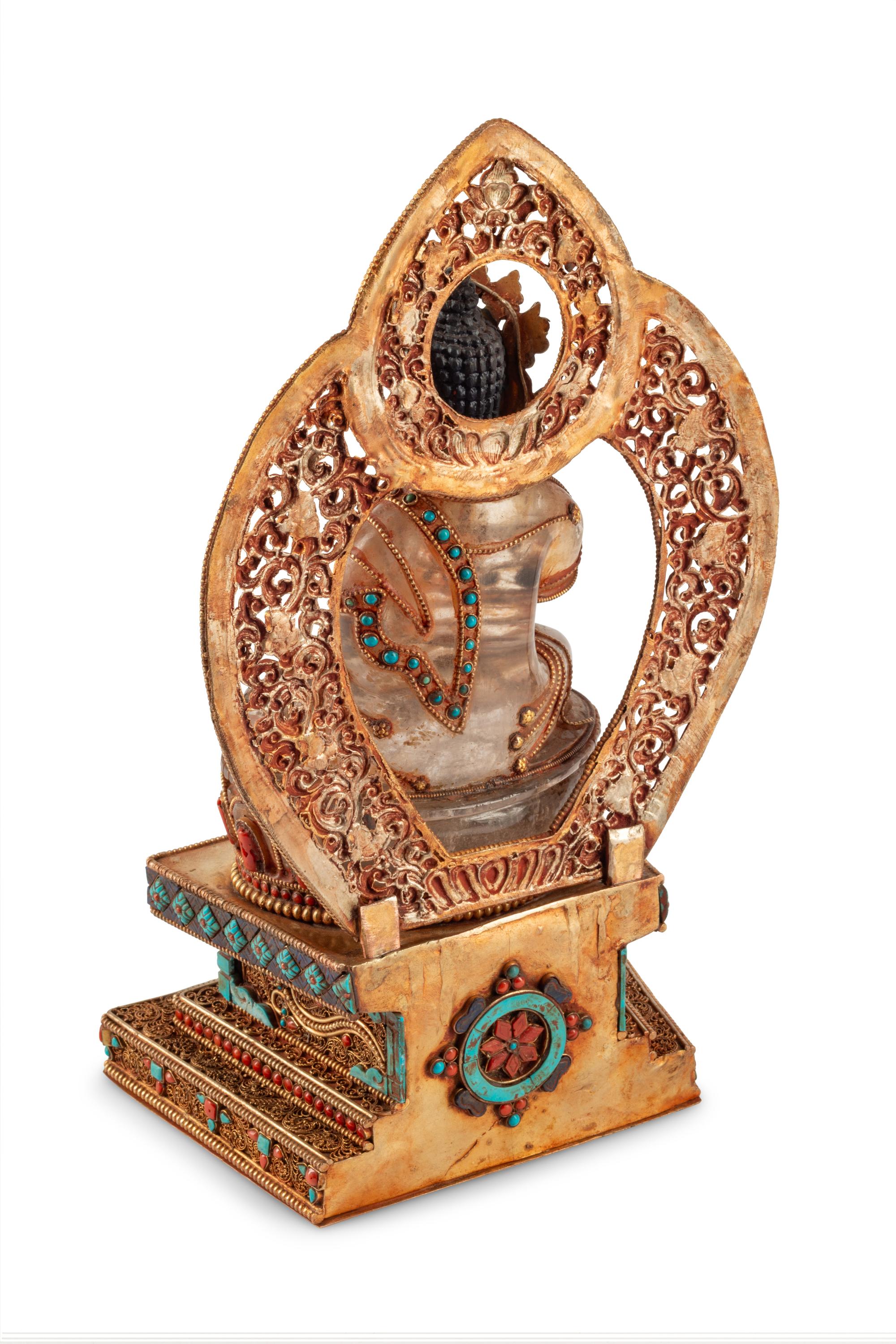 A Tibetan Style Rock Crystal, Gilt Metal Filigree, Turquoise and Carnelian Deity