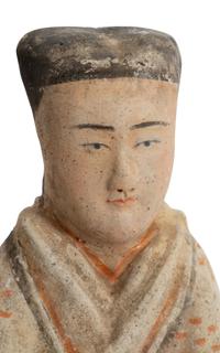 A Chinese Pottery Figure of a Female Attendant