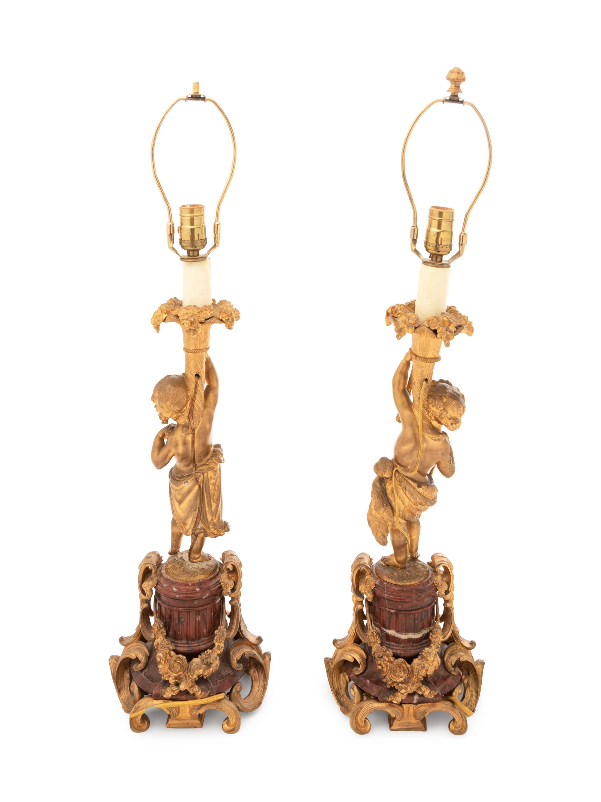 A Pair of Louis XV Style Gilt Bronze Figural Candlesticks