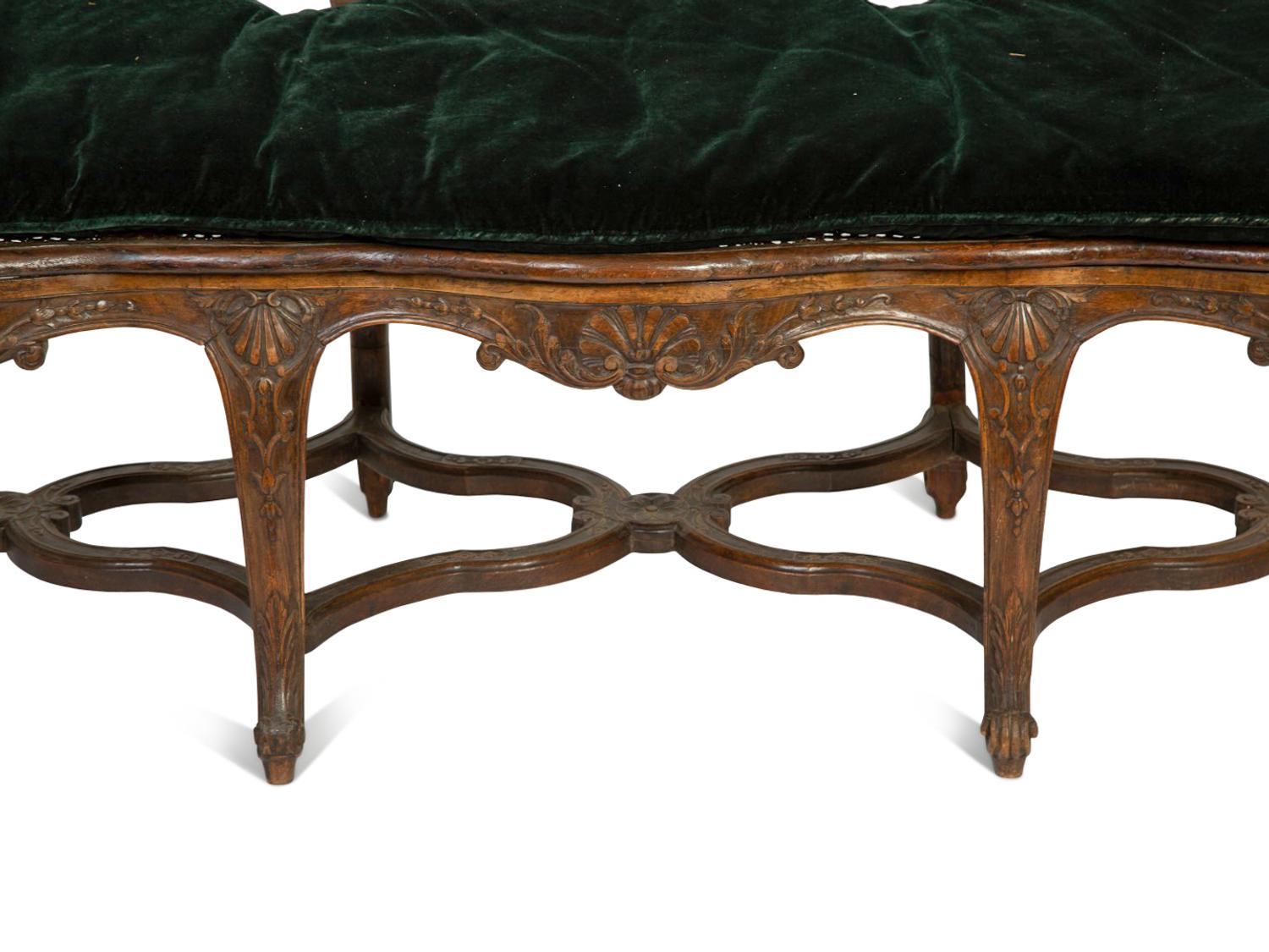 A Régence Style Carved Walnut Triple Chair-Back Settee