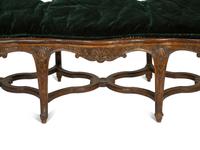 A Régence Style Carved Walnut Triple Chair-Back Settee