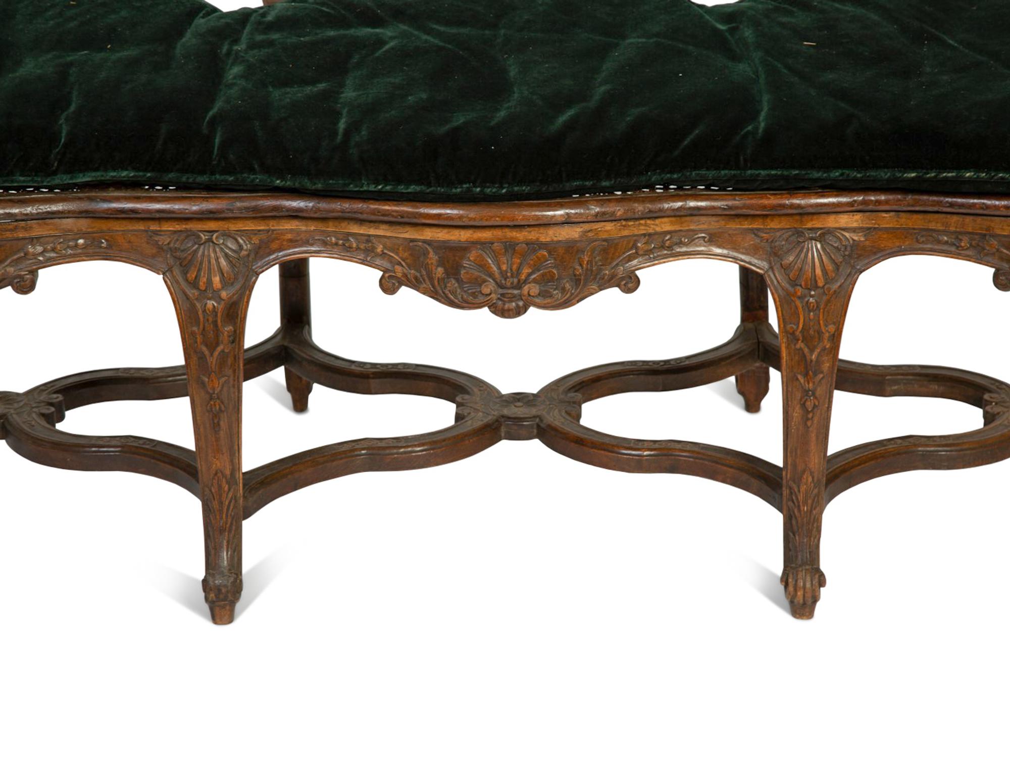 A Régence Style Carved Walnut Triple Chair-Back Settee