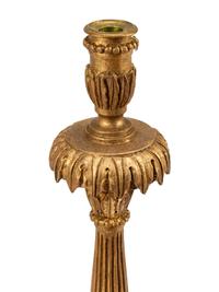 A Pair of Italian Neoclassical Carved and Parcel Gilt Candlesticks