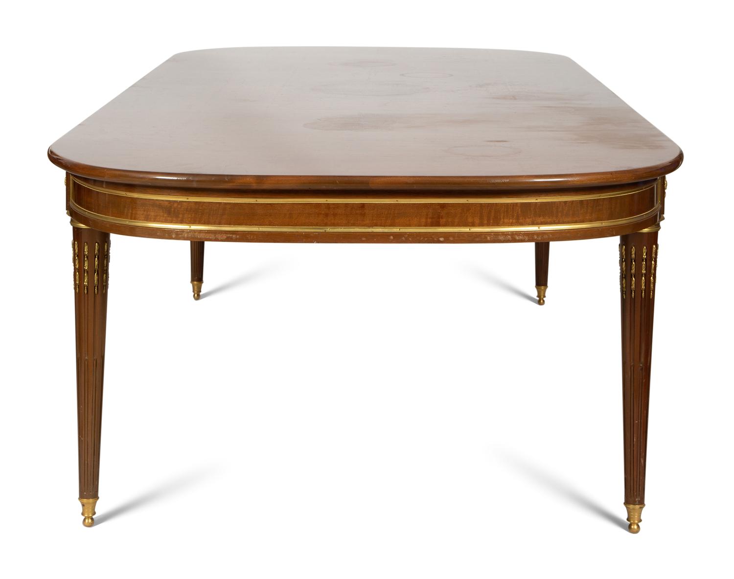 A Louis XVI Style Gilt Bronze Mounted Mahogany Dining Table