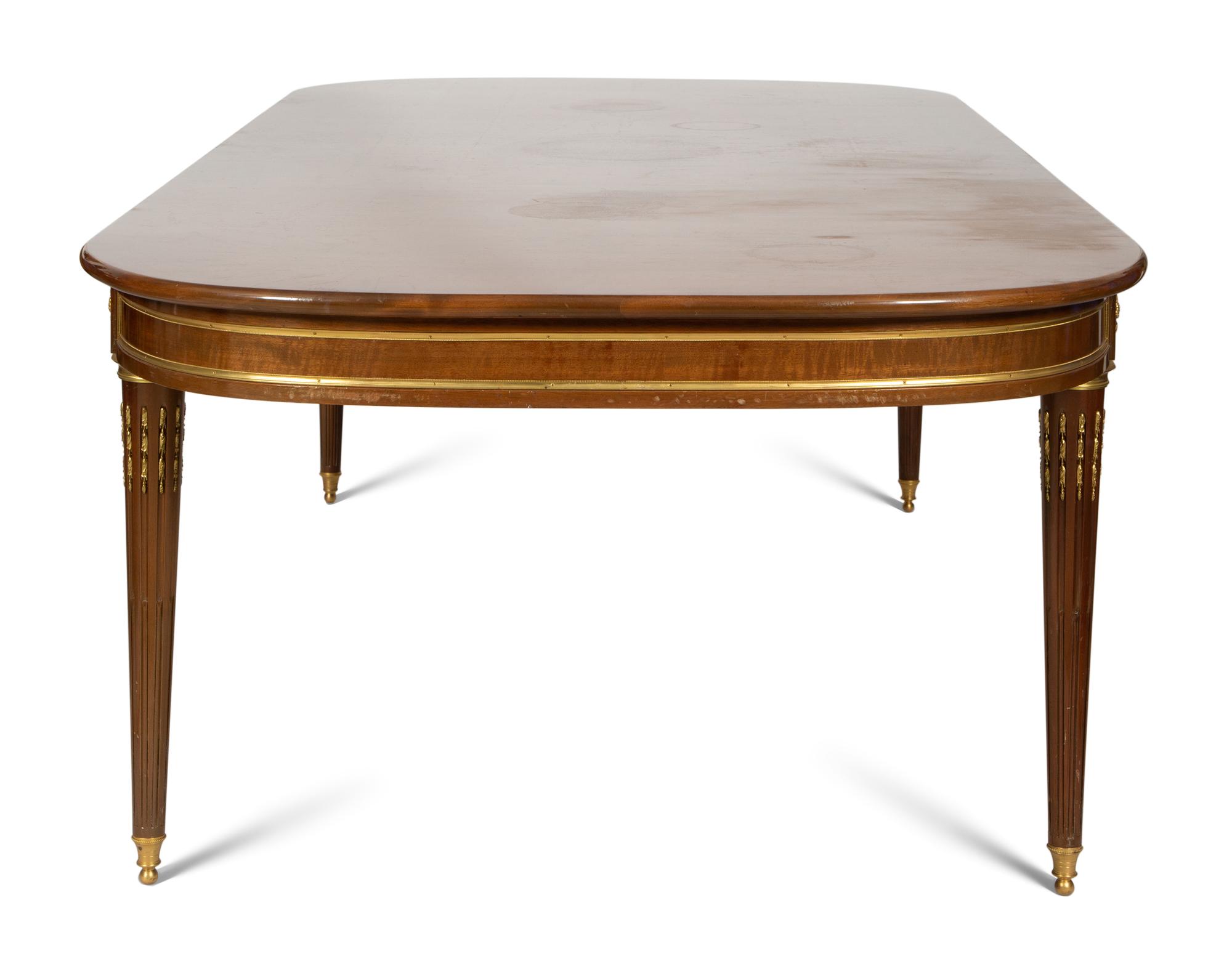 A Louis XVI Style Gilt Bronze Mounted Mahogany Dining Table