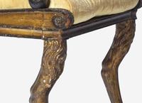 A Set of Three Regency Parcel-Gilt and Ebonized Caned Seat Dining Chairs