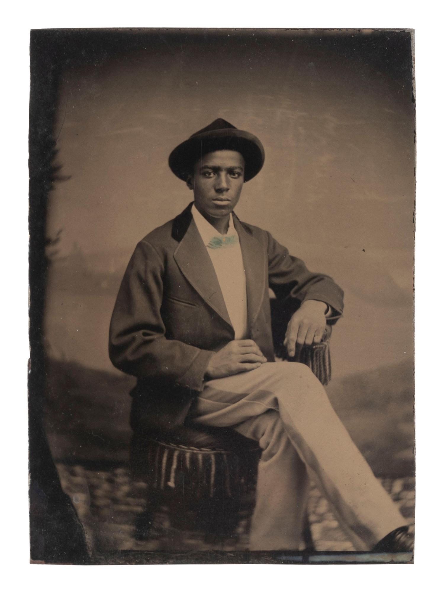 [AFRICAN AMERICANA - EARLY PHOTOGRAPHY]. Tintype of young African American man, likely occupational.