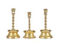 A Group of Three Flemish Brass Candlesticks