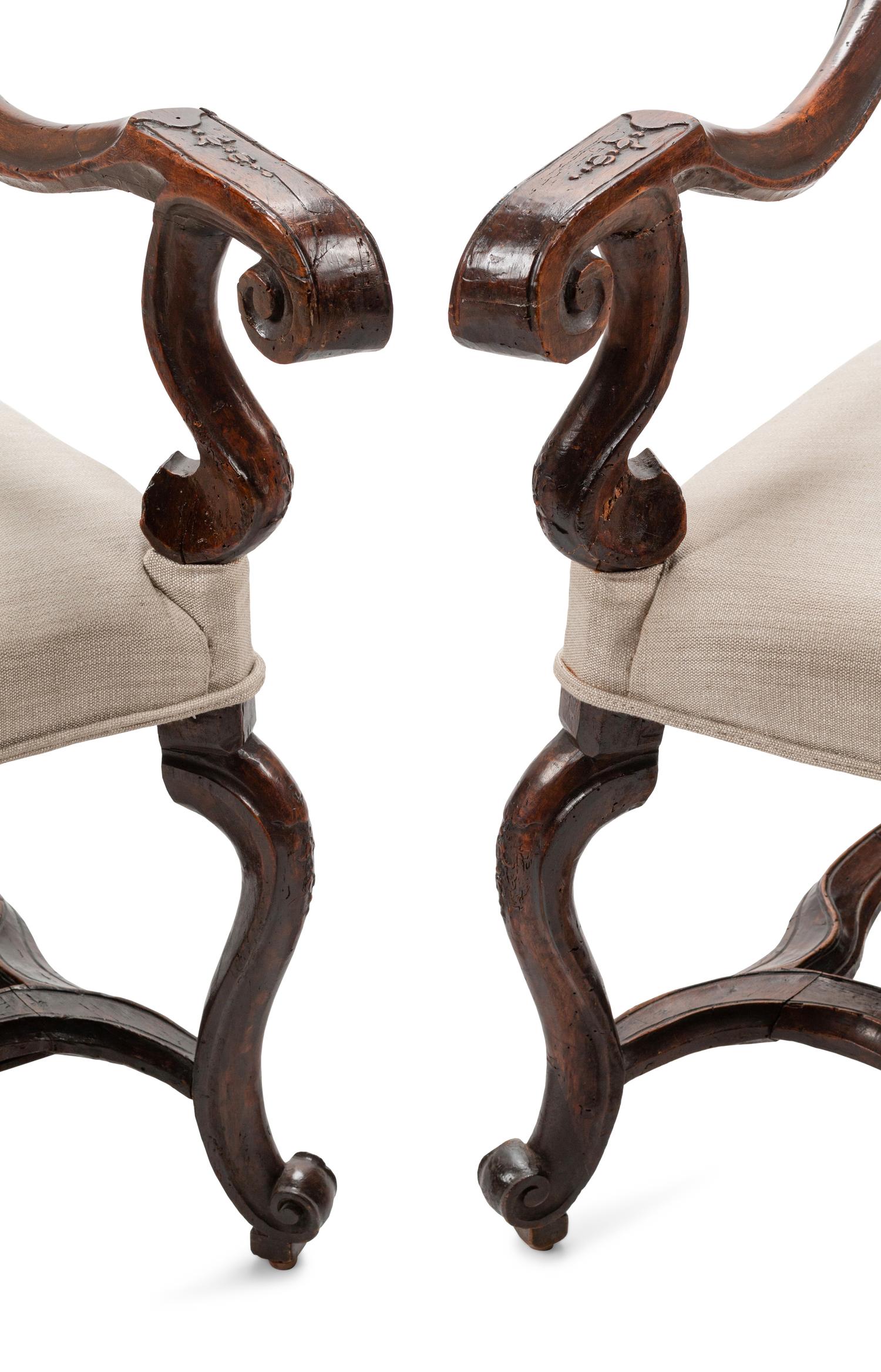 A Pair of Régence Carved Walnut Fauteuils