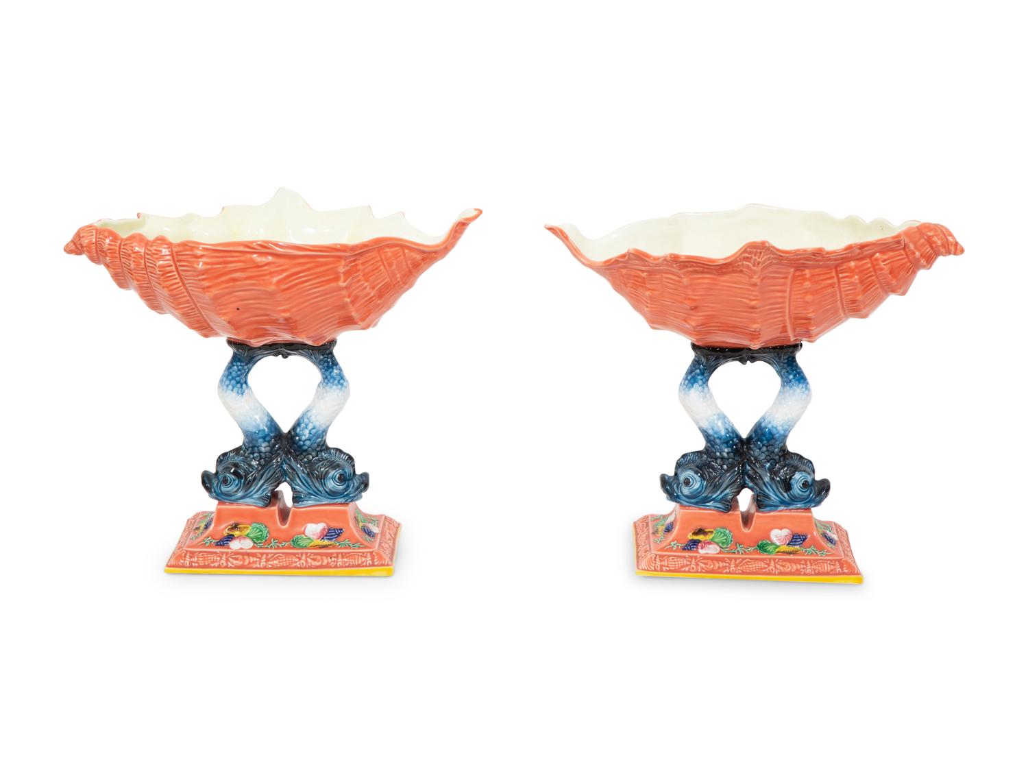 A Pair of Italian Glazed Ceramic Shell-form Compotes on Dolphin Supports