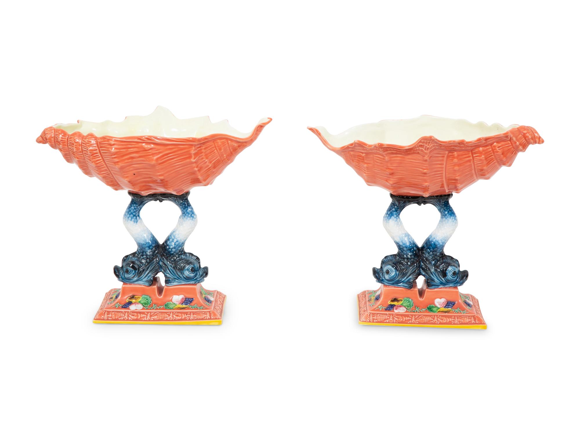 A Pair of Italian Glazed Ceramic Shell-form Compotes on Dolphin Supports