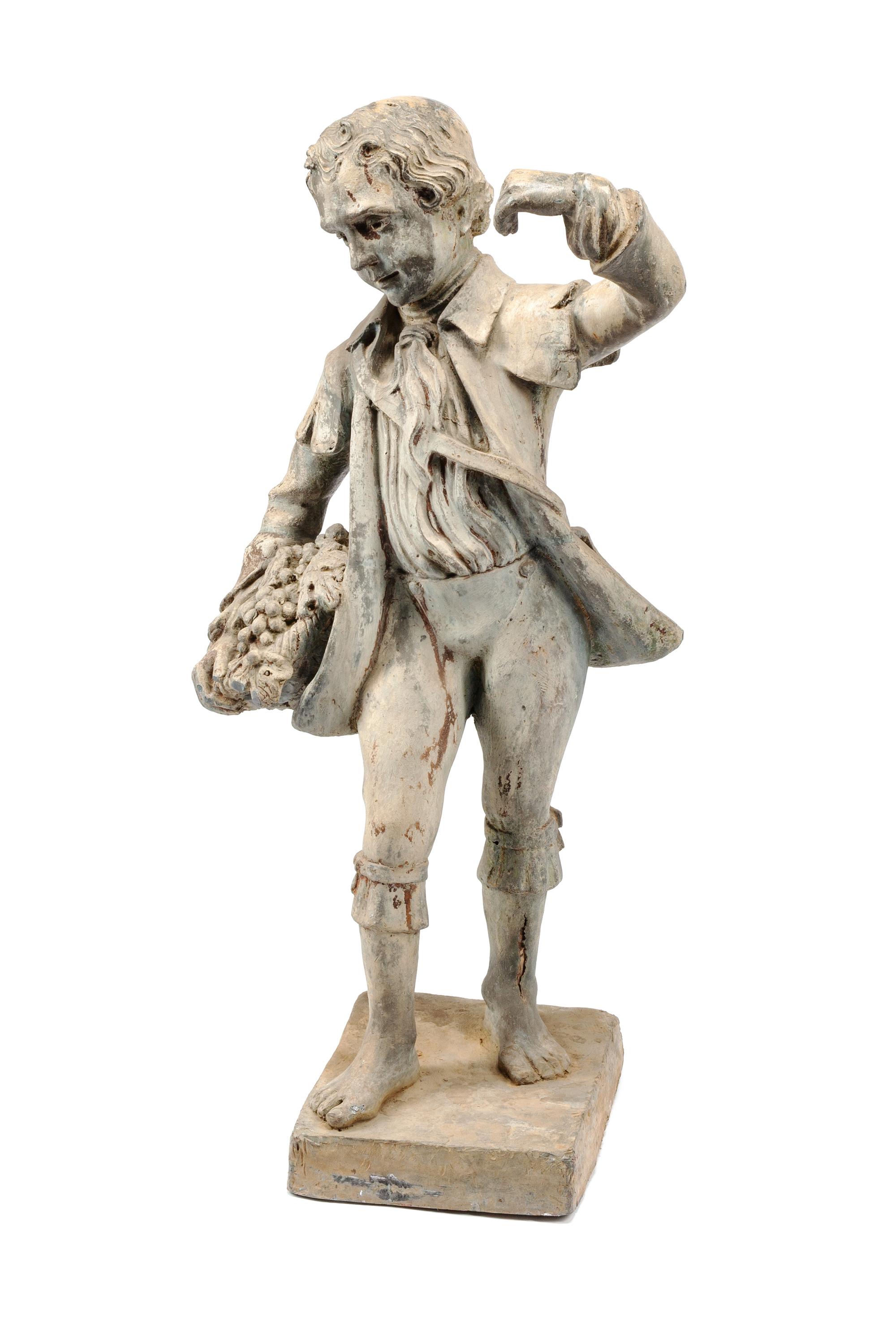 A Cast Lead Figure of a Boy with Grapes