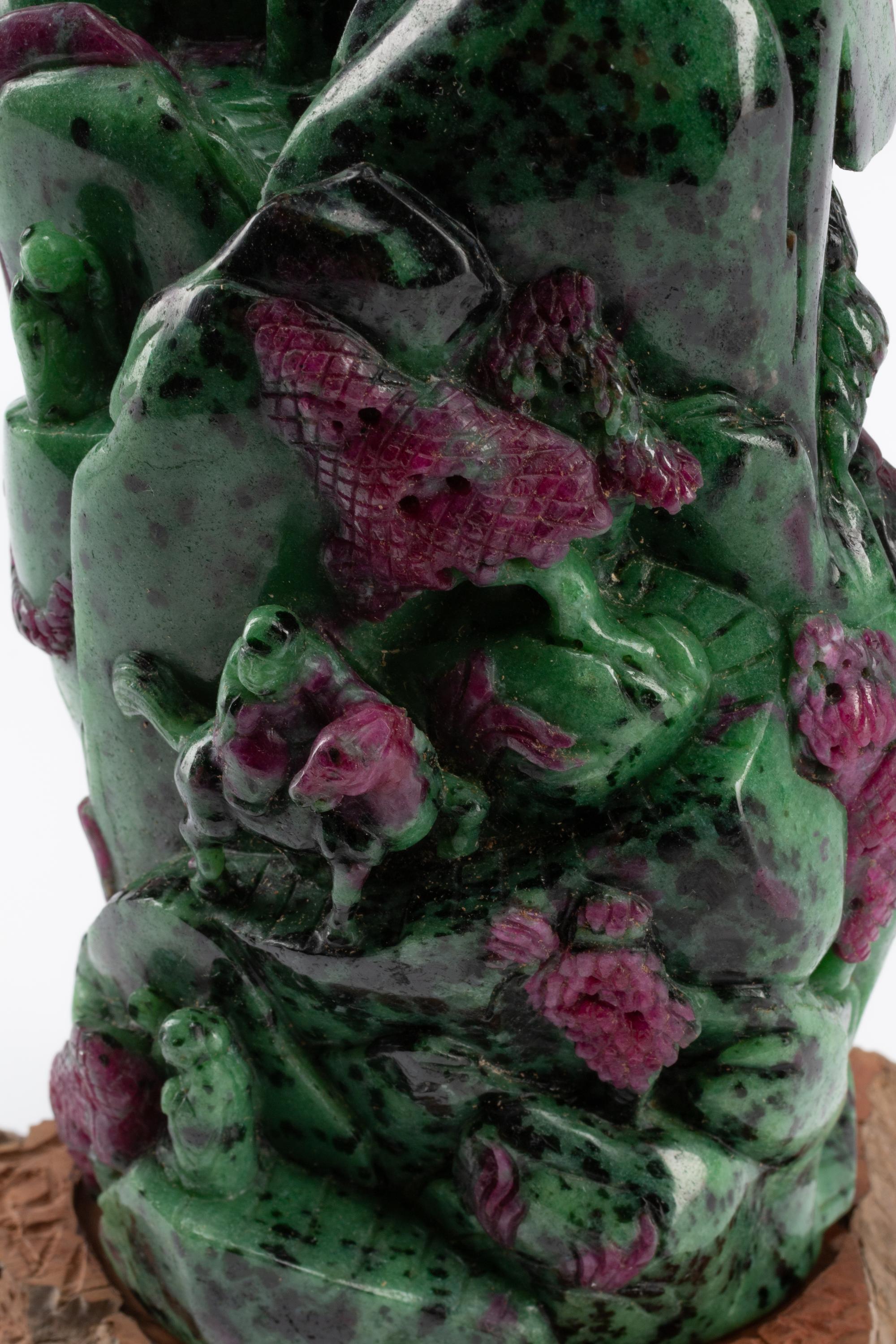 A Chinese Carved Ruby Zoisite Boulder on a Wood Base